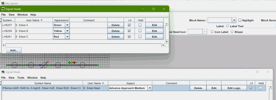 Image showing a JMRI Layout Editor panel
             with some track, a level crossing, and a three-head signal mast
             protecting leftward movement over the level crossing.